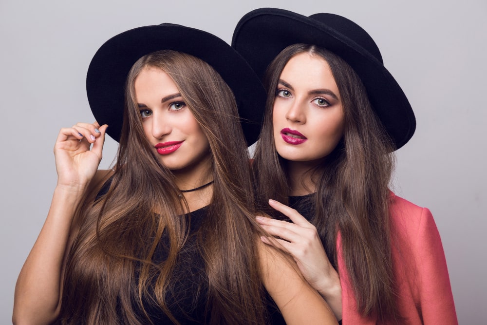 “Model wearing long tape-in hair extensions with natural volume and shine”